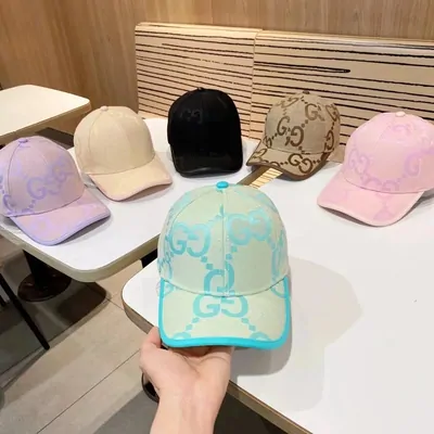 Gucci GG logo baseball caps in a pile