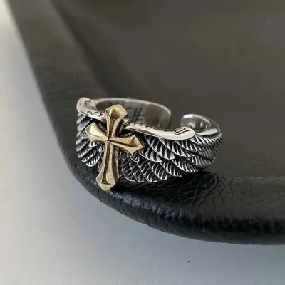 Angel wings and cross ring close-up