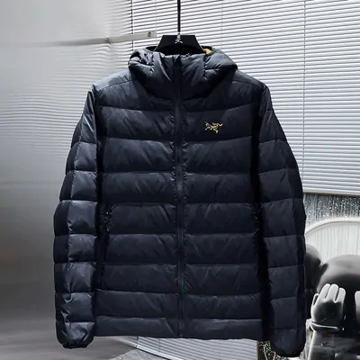 Black hooded down jacket laid flat