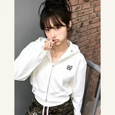 White zip-up hoodie outfit worn by a model